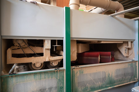 Grinding of wooden furniture panels on a machine. Furniture production conceptの写真素材