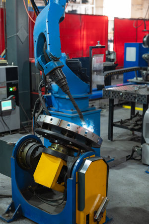 Automatic Industrial welding robot in a modern factory in operation.の写真素材