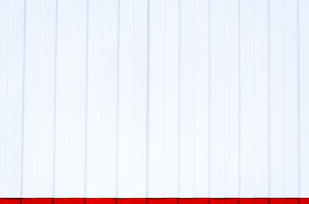 White urban steel wall with a red stripeの写真素材