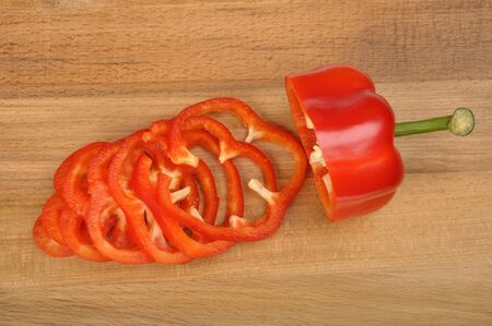 red pepper sliced on a worn cutting boardの写真素材