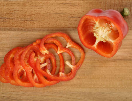 red pepper sliced on a worn cutting boardの写真素材