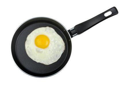 fried egg in a frying pan isolated on white backgroundの写真素材