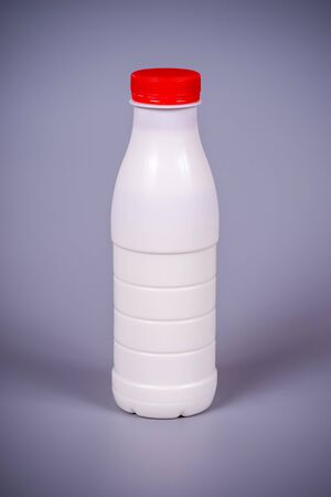 Milk in a plastic bottle with a red cork on a gray backgroundの写真素材