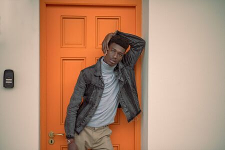 Portrait of young man standing in doorwayの写真素材