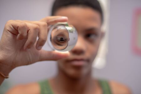 Young boy holding crystal ball in handの写真素材
