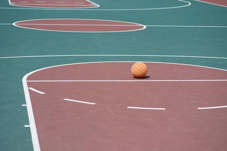 Basketball on court with nobody in sight 
