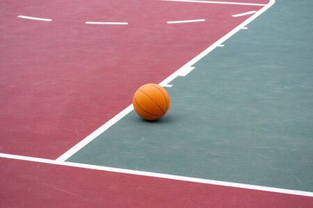 Basketball on empty sports courtの写真素材