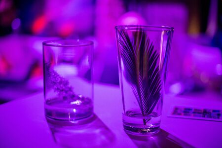 Glasses on table inside night clubの写真素材