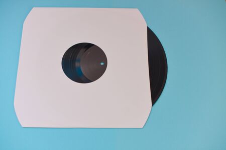 Vinyl record in sleeve isolated against blue background