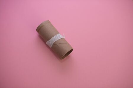 Empty roll of toilet paper isolated against pink backgroundの写真素材