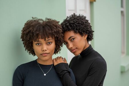 Portrait of two stylish sisters with curly hairの写真素材
