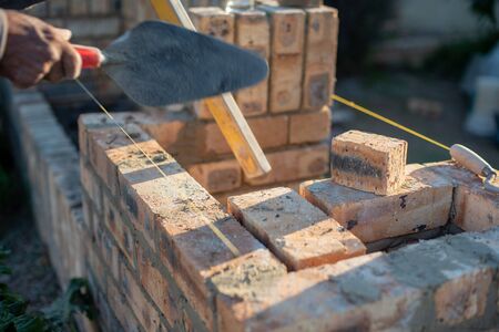 Motion blur on worker using trowel at construction siteの写真素材