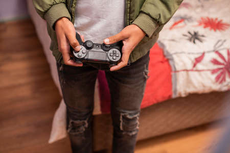 Cropped shot of young person playing video gamesの写真素材