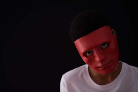 Portrait of scary looking person in dark room