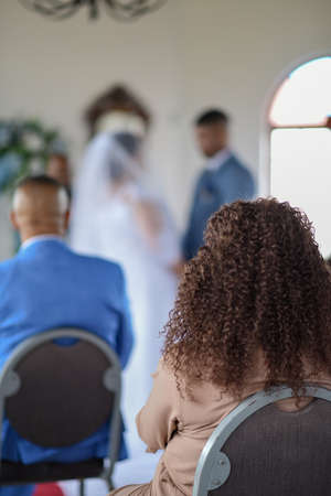 Rear view of audience member watching wedding ceremonyの写真素材