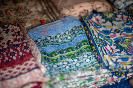 Selective focus on colorful scarfs on display at market