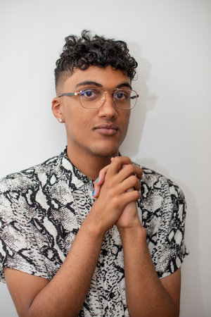 Portrait of young adult standing against white background