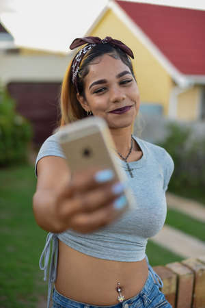 Portrait of young woman using her mobile phoneの写真素材