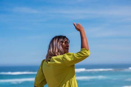 Woman shielding her face from the sun
