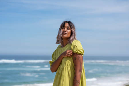 Portrait of confident woman showing her tattoos