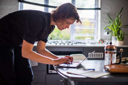 woman working remotely from home using laptopの写真素材