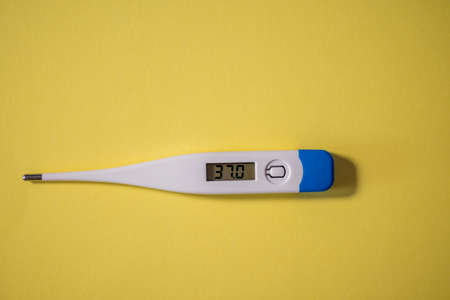 Digital thermometer isolated against yellow backgroundの写真素材