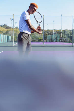 Young man seen waiting for ball on tennis court