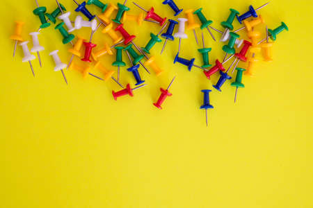 Thumb tacks isolated against colorful backgroundの写真素材