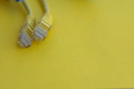 Lan cables isolated against yellow background