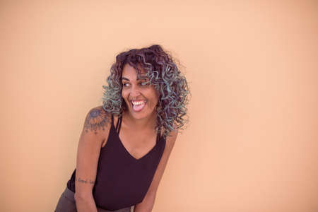 Portrait of happy woman sticking her tongue outの写真素材