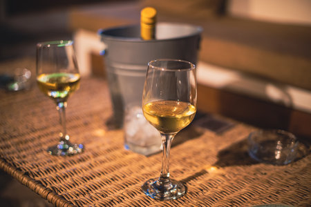Close up shot of two glasses of wine on tableの写真素材