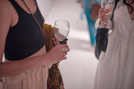 Cropped shot of woman holding wine glass in handの写真素材