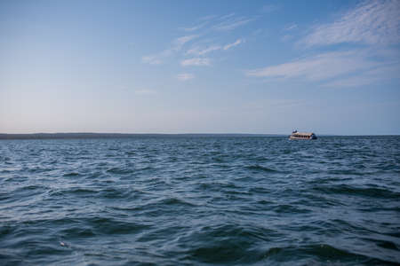 Ferry seen traveling across ocean with clear sky
