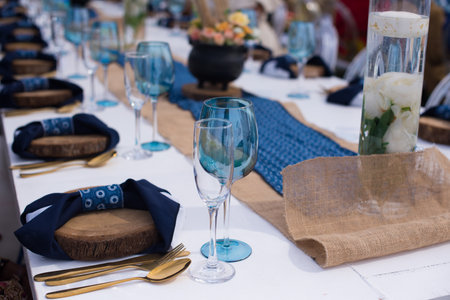 Table laid out for event with cutlery and glasses