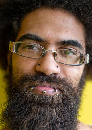 Close up portrait of man with big beard and pierced lipsの写真素材