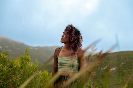 Woman seen staring upwards seen through branch twigの写真素材
