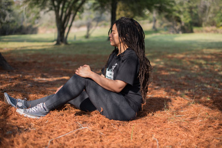 Woman seen relaxing outdoors in parkの写真素材