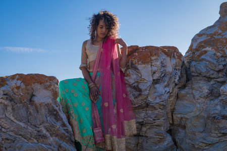 Beautiful woman seen sitting on rocks