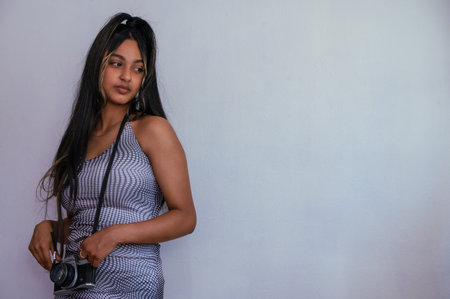 Portrait of young woman with camera