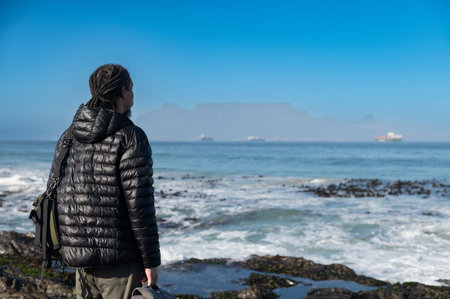 Rear view of man seen standing and looking at table mountain