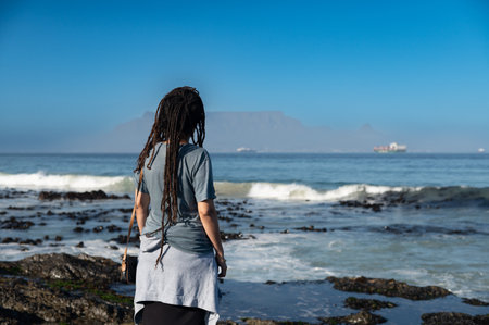 Woman standing and looking at table mountainの写真素材