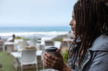 Woman seen cusping cup with coffeeの写真素材