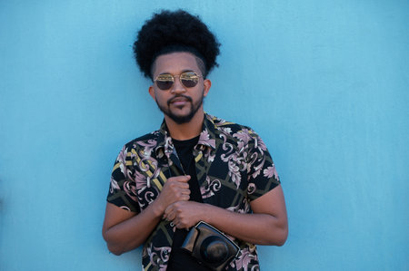 Portrait of stylish man shot against blue wallの写真素材