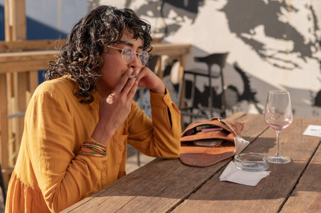 Woman seen smoking a cigarette outdoors
