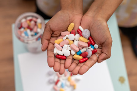 Close up shot of hand filled with capsules and tabletsの写真素材