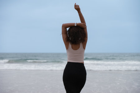 Rear view of happy woman at the beach