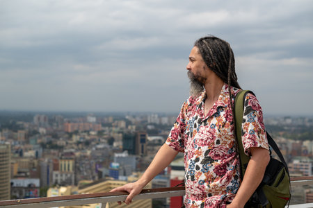 Side view of man seen looking at city