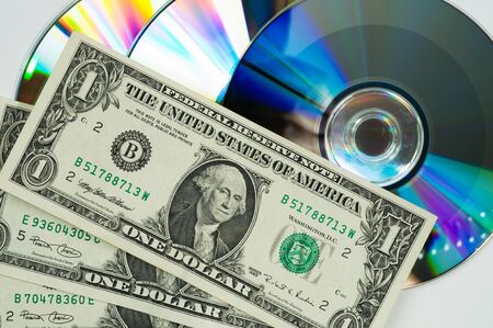 computer disks and dollars on a gray backgroundの写真素材