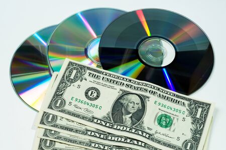 computer disks and dollars on a gray backgroundの写真素材