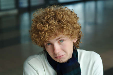 portrait of a young man with curly hairの写真素材